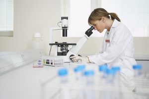 Natural Immunogenics | Lab Assistant with Microscope