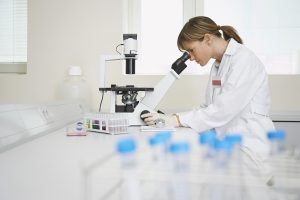 Natural Immunogenics | Lab Assistant with Microscope